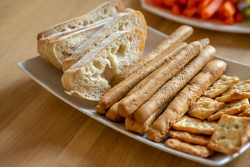 Plate with breadsticks and ciabatta