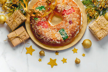 Roscon de reyes with cream and christmas ornaments. Kings day concept spanish three kings cake