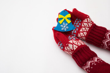 Woman hand with chrismas toy isolated on white