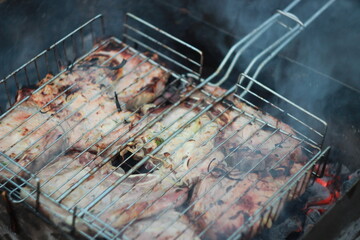 delicious juicy barbecue skewers on a grill with a smoke