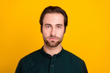 Photo of strict young bossy guy wear green shirt isolated on yellow color background