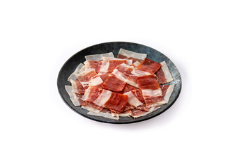 Spanish serrano ham slice on black plate isolated on white background