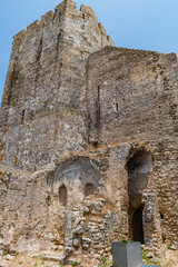 Fototapeta premium Perspective of ruined old chapel wall in Palmela castle with tower, PORTUGAL