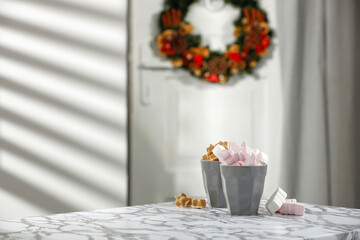 Christmas marshmallows in a cup on the table on a beautiful winter's day 
