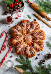 Christmas star bread with cranberry jam on grey Christmas background