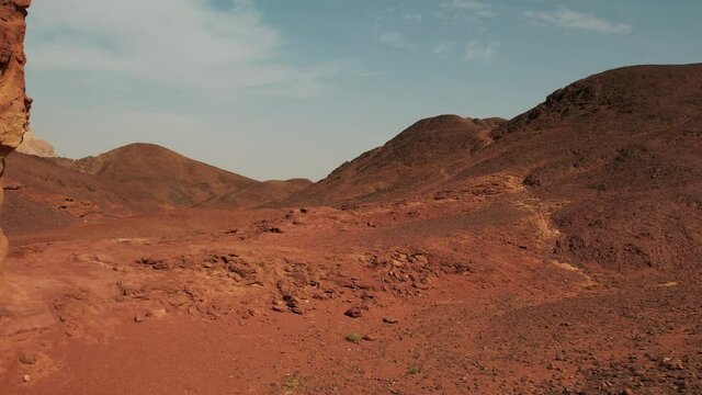 Revealing aerial shot of a beautiful desert, extremely colorful and big sand mountains in the background of the reveal. 60 FPS.