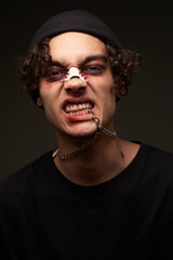 male boxer with bruises under his eyes training blood aggression