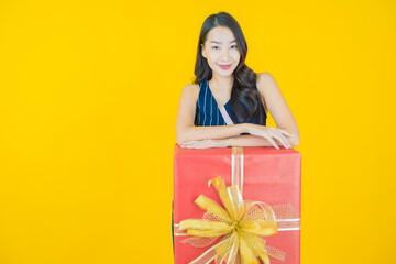 Portrait beautiful young asian woman smile with red gift box