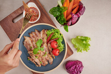 Grilled steak with mixed vegetables and spices. Home made tasty food. stone background. Pork steak with salad. Grilled pork is one of the most popular thai dishes. Grilled pork with spicy dip.
