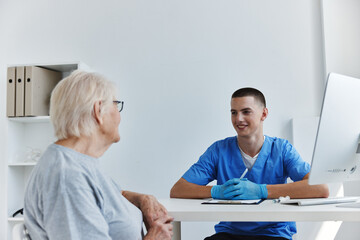 Fototapeta premium elderly woman talking to the doctor health treatment