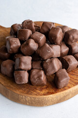 Chocolate covered Turkish delight on a white background. Traditional Turkish cuisine flavor. Story format