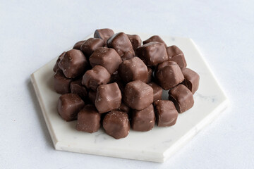 Chocolate covered Turkish delight on a white background. Traditional Turkish cuisine flavor. Close up