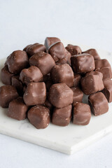 Chocolate covered Turkish delight on a white background. Traditional Turkish cuisine flavor. Story format