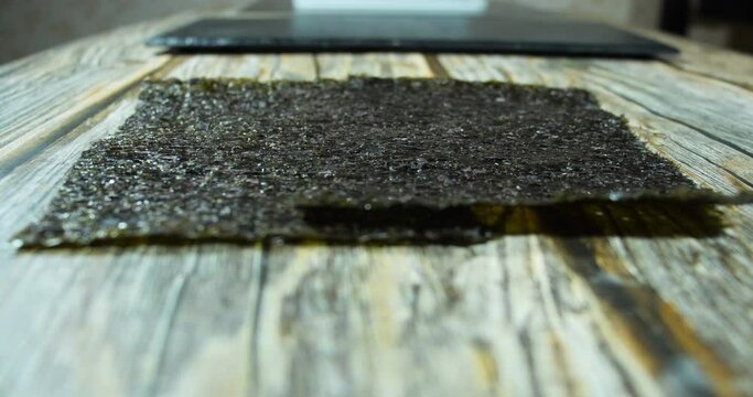 nori sheets fall on a wooden table