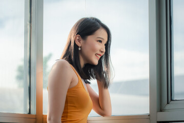 Happy cute pretty asian woman relaxing at home on the weekend.