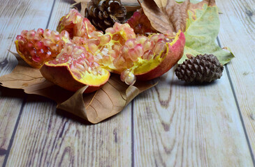 Open pomegranate in the shape of a flower, in full detail, on wooden boards and copy space.