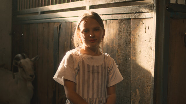 Positive girl in rustic stable