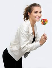Laughing girl holding big lollipop.grimacing woman