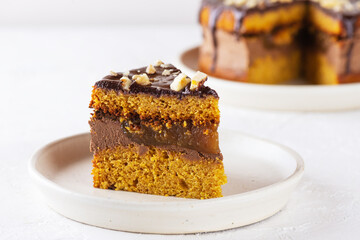 Piece of American pumpkin cake with orange on a light background. Sugar, gluten, lactose free, vegan.