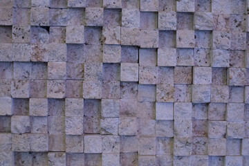 Old beige stone wall background texture close up