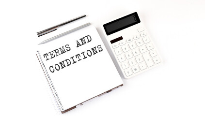 Notepad with text TERMS AND CONDITIONS with calculator and pen. White background. Business concept