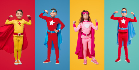 Kids in superhero costumes showing muscles