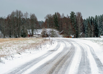 winter landscape with a snowy country road and snow-covered trees on the side of the road, winter