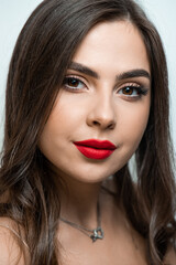 Beautiful young woman with make up and red lips