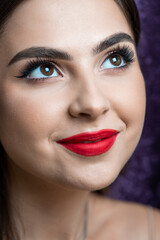 Fototapeta premium Beautiful young woman with make up and red lips