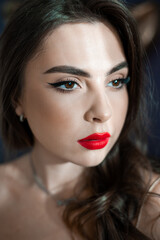 Beautiful young woman with make up and red lips