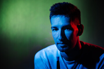 male portrait with green and blue filters and hookah pipe