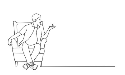 Young man sits in a chair and talks.