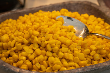  Salad buffet in the restaurant, bowl with pieces of corn,.