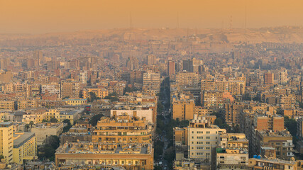 Fototapeta premium Cairo from above. Top view over the buildings from capital of Egypt country during a summer sunset.