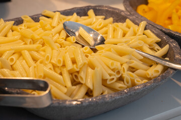 Healthy food buffet in restaurant. Cooked macaroni bowl.