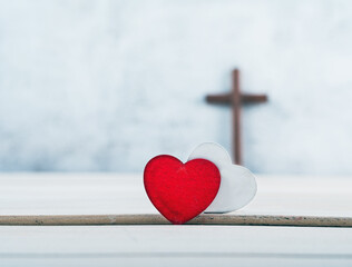 wooden cross and Two red and white hearts on wood background, GOD IS LOVE concept.