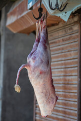 Ram carcass hanging on a hook and is being prepared for sale. Srinagar, Jammu and Kashmir state, India.