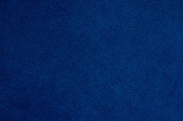 The texture of the fabric is velor in dark blue. Background Velvet upholstery furniture