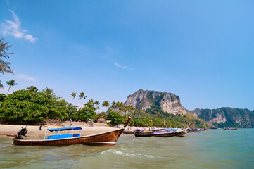 Plakat Travel by Thailand. Landscape with traditional longtail fishing boats on the sea beach.