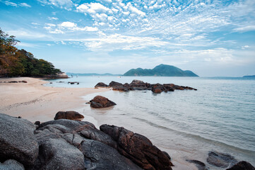 Tropical landscape. Rock and sand sea beach.