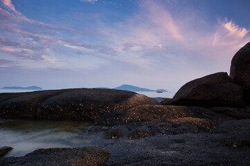 Big rocks and stones at the sea beach on daybreak.