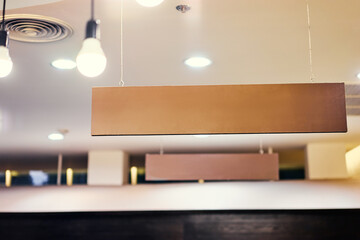 Signboard hanging from the ceiling indoors.