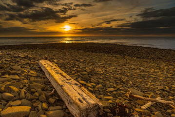 Sunset at low tide on rocky shore of bay of fundy