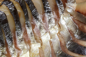 Food background, fish smoked mackerel fillet cut into slices, seafood close-up top view, contains...