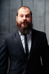 Gentlemen fashion and style. Handsome young bearded man at suit and tie.