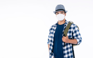 New normal lifestyle travel vacation concept. Traveler adventure handsome young man wear casual shirt, hat and protective mask safety with backpack standing over isolated white background.