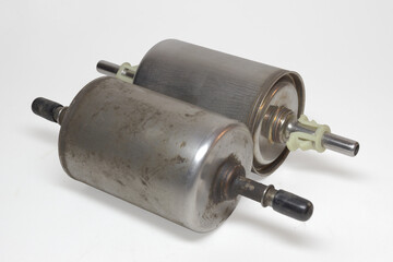 gasoline in-line filter pair, cap on fitting of dismantled one to prevent fuel pouring. on white...