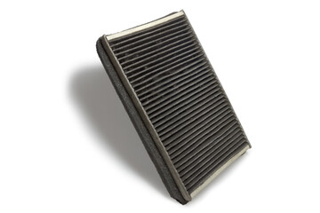 cabin air filter, used, with clogged carbon filtering media, drops shadow on white background