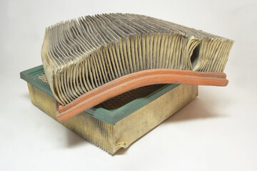 engine air filter of automotive air intake system. Stack of two used, dusty filters with colored...