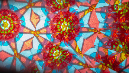 A pattern of multicolored glasses in a children's kaleidoscope - obrazy, fototapety, plakaty